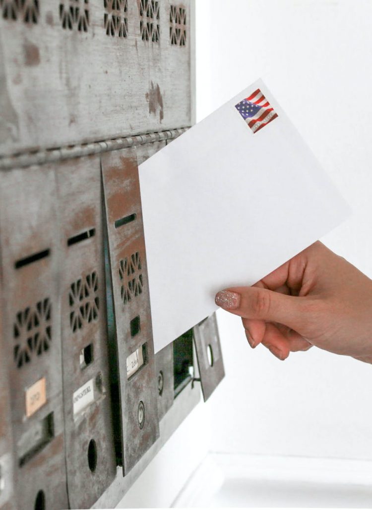 person holding white envelope