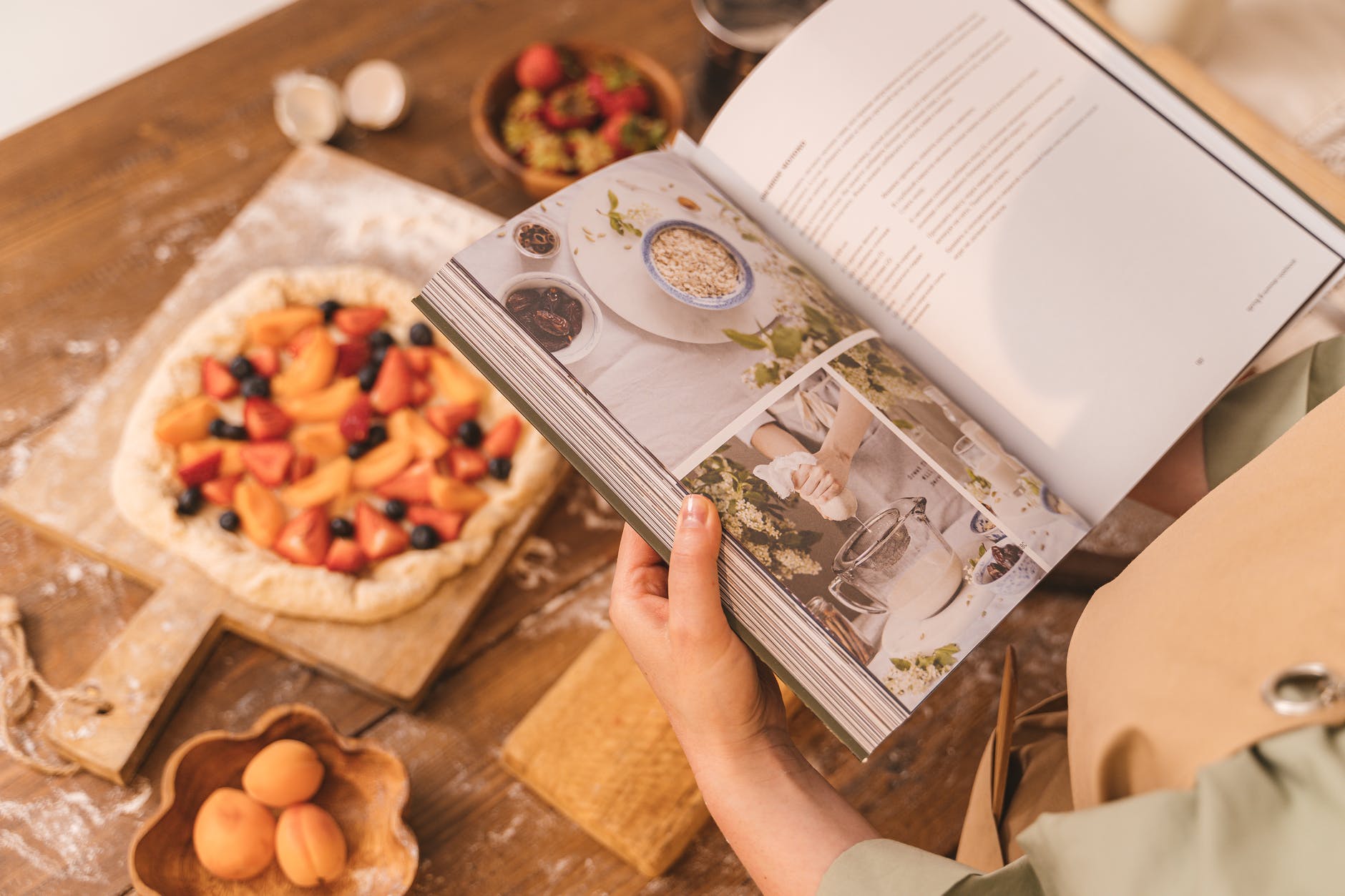 person holding cookbook